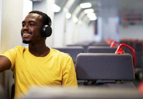 Man listening to announcement from audio communication system