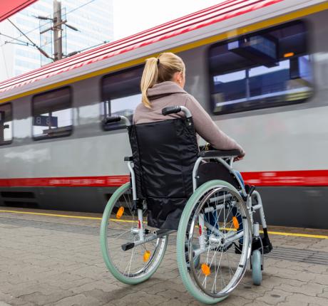 woman in wheel chair next to train