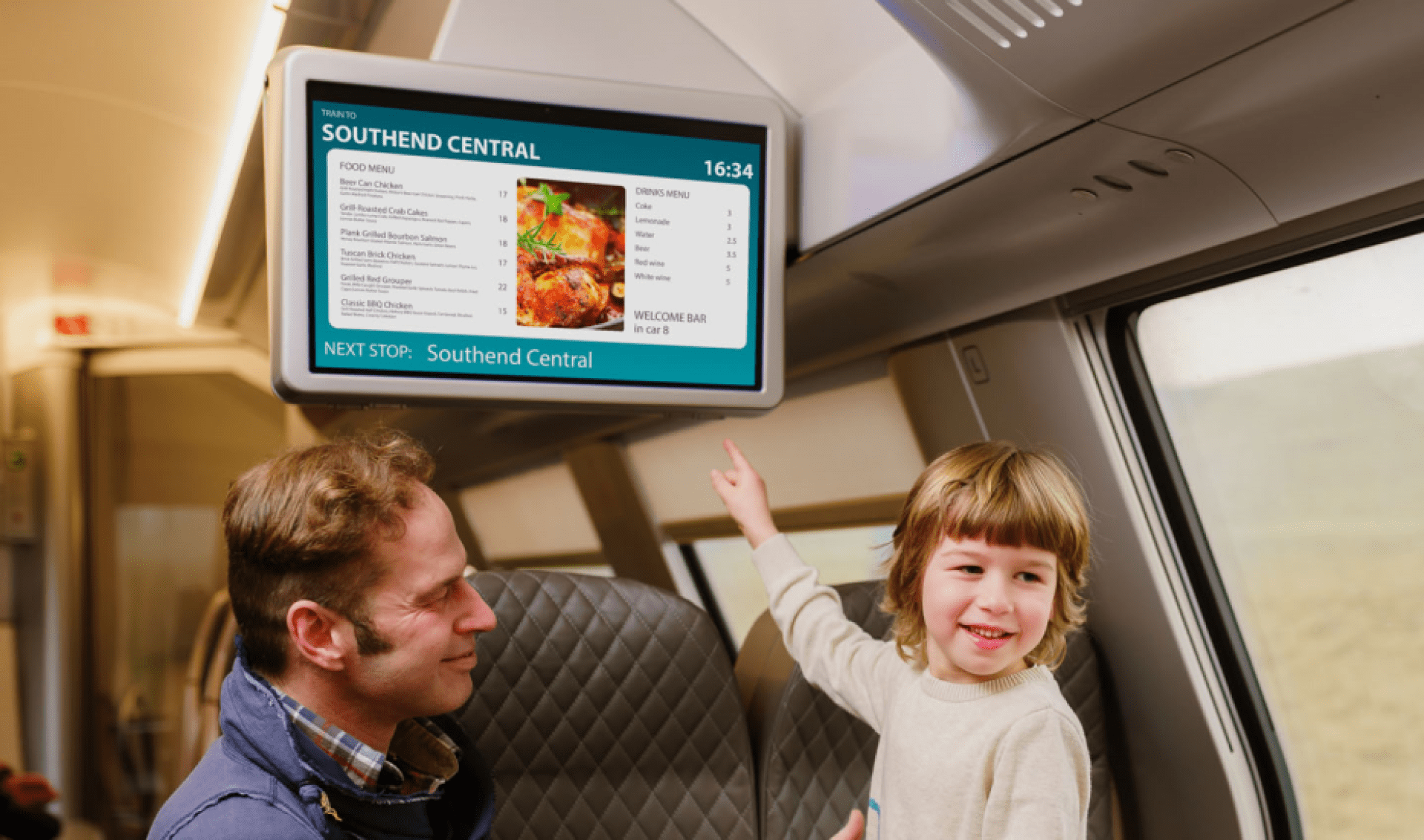 Boy pointing at TFT display in train, visual information